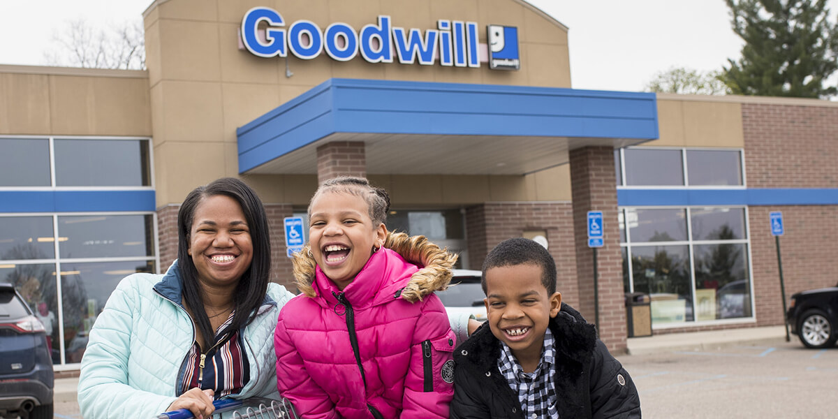 photo from Goodwill showing smiling shoppers outside a Goodwill store