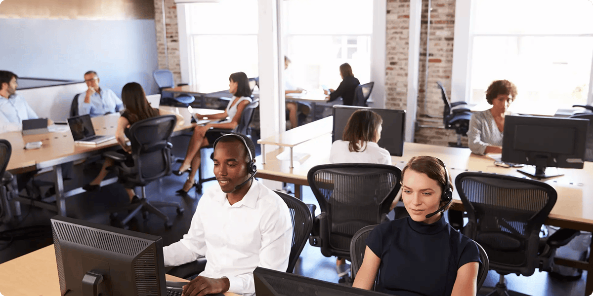 image of an office with people working on computers, from aptean